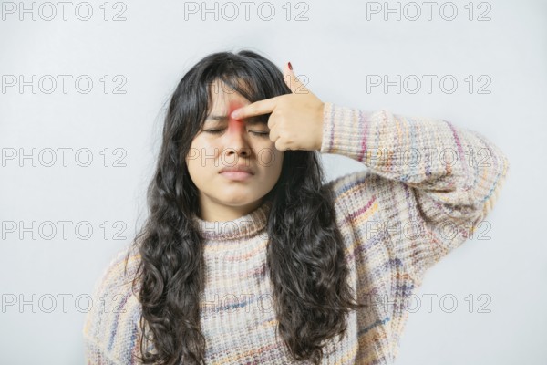 Asian woman with nasal bridge pain isolated. Girl with nasal bridge ache isolated