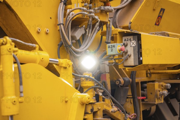 Close-up of yellow machine parts with cables and technical details, tamping machine on Hermann, Hesse, railway, Althengstett, Calw district, Germany