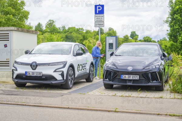 Electric cars park with a view of charging station, surrounded by green vegetation, Deer E-Carsharing, Calw, Germany