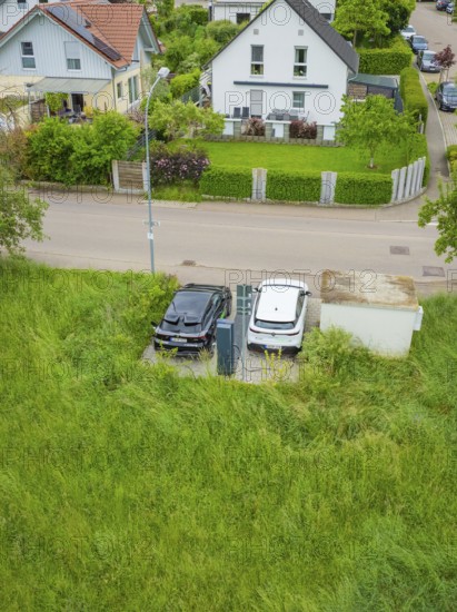 Aerial view of electric cars at a charging station in a residential area, Deer E-Carsharing, Calw, Germany
