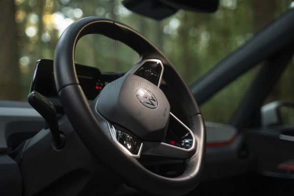 Close-up of a steering wheel in a car with a wooded background, Deer e-Carsharing, VW ID3, Calw, Germany