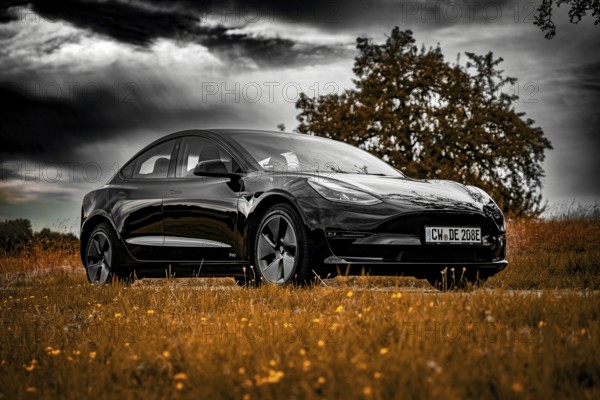 Black car parked on country road, dramatic clouds in the sky surrounded by meadows, Deer E-Carsharing, Tesla Model 3, Calw, Germany