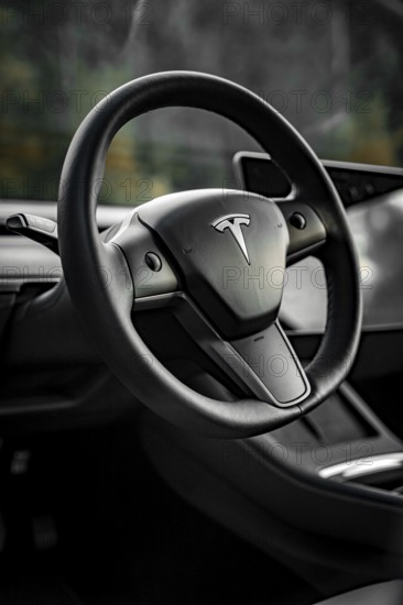 Close-up of a black steering wheel in a modern vehicle interior, Deer e-Carsharing, Tesla Model 3, Calw, Germany