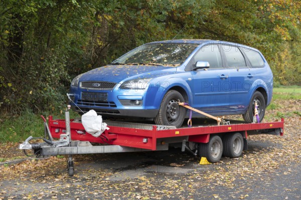 Car loaded onto a car trailer for transport, Bavaria, Germany