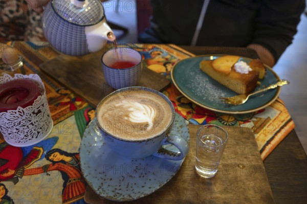 Cappuccino, tea and cake served in a Persian café, Fürth, Mittelfranken, Bayern, Germany