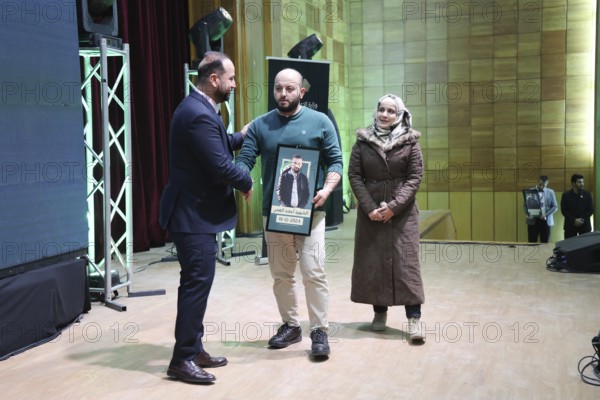DAMASCUS, SYRIA - DECEMBER 6, 2025: Ministers and high-ranking officials of the newly formed Syrian government attend a symbolic ceremony to honor the families of victims who lost their lives during the Syrian war. The event, held in the capital Damascus, aims to provide social and symbolic recognition to the relatives of those fallen during the conflict as part of the country's transitional or commemorative phase, Damascus, Damascus, Syria