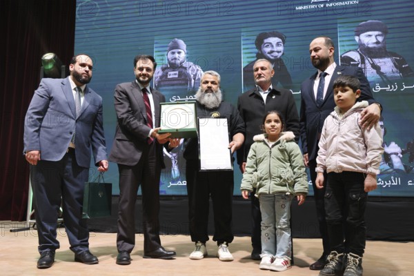 DAMASCUS, SYRIA, DECEMBER 6, 2025: Ministers and high-ranking officials of the newly formed Syrian government attend a symbolic ceremony to honor the families of victims who lost their lives during the Syrian war. The event, held in the capital Damascus, aims to provide social and symbolic recognition to the relatives of those fallen during the conflict as part of the country's transitional or commemorative phase, Damascus, Damascus, Syria