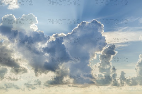 A stunning display of colorful clouds fills the sky as the sun sets, creating a dramatic and scenic backdrop for evening moments