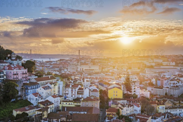 Stunning sunset over Lisbon at Miradouro da Senhora do Monte, with views of Carmo Convent and the 25th of April Bridge