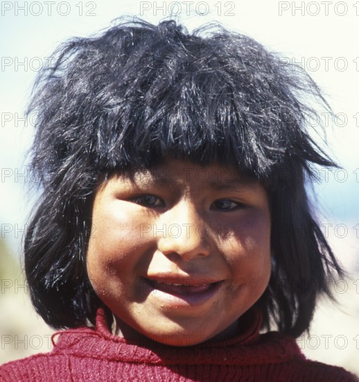 Portrait of a cheerful little girl on Isla Taquile in Lake Titicaca, Andean Highlands, Peru, South America, September 1997, vintage, retro, old, historical