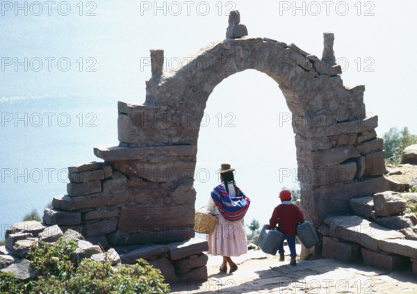 Archway, traditionally dressed woman, child on Isla Taquile in Lake Titicaca, Andean highlands, Peru, South America, September 1997, vintage, retro, old, historic