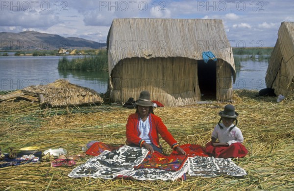 Mother and little daughter sell souvenirs on a floating Uro island in Lake Titcaca, Andean highlands near Puno, South America, September 1997, vintage, retro, old, historic