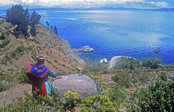 Traditionally dressed woman, port, Isla Taquile in Lake Titicaca, Andean highlands, Peru, South America, September 1997, vintage, retro, old, historic