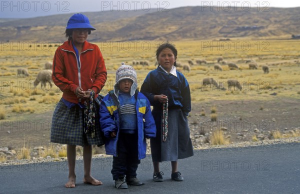 Children sell cheap jewelry on the roadside near Puno, Andean Highlands, Peru, South America, September 1997, vintage, retro, old, historic