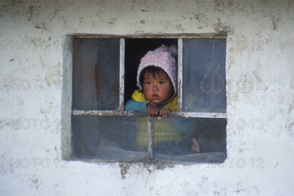 Little child looking out of a window near Cusco, Andean Highlands, Peru, South America, September 1997, vintage, retro, old, historic