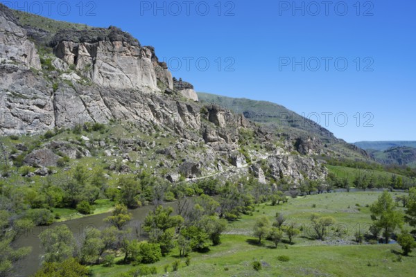 A river flows through a green valley with rocky slopes and trees, Kura River, landscape near Vardzia, Samtskhe—Javakheti region, Samtske Javacheti, Lesser Caucasus, Georgia