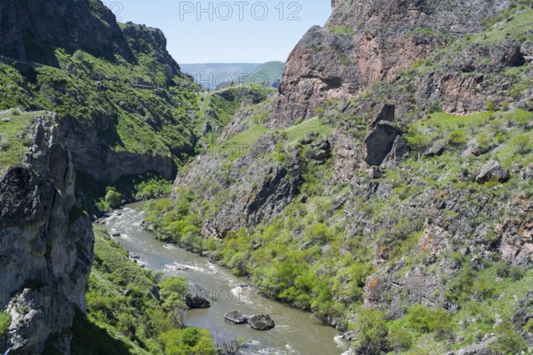A river flows through a narrow green gorge with steep rocky slopes, Kura River, Gorge near Vardzia, Samtskhe—Javakheti Region, Samtske Javacheti, Lesser Caucasus, Georgia
