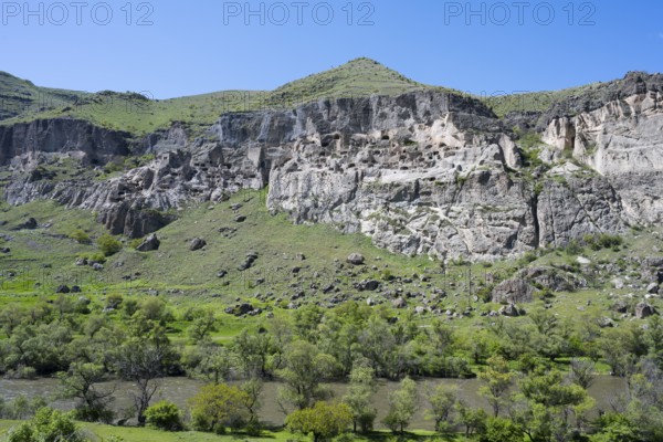 Green hills and imposing cliffs with picturesque skies. Pristine natural scenery, cave town, cave monastery, Kura River, Vardzia, Samtskhe—Javakheti region, Samtske Javacheti, Lesser Caucasus, Georgia