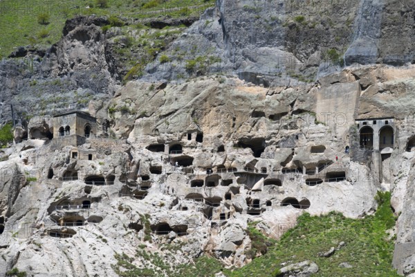 A rocky wall with numerous cave openings carved into the stone, cave town, cave monastery, Vardzia, Samtskhe—Javakheti region, Samtske Javacheti, Lesser Caucasus, Georgia