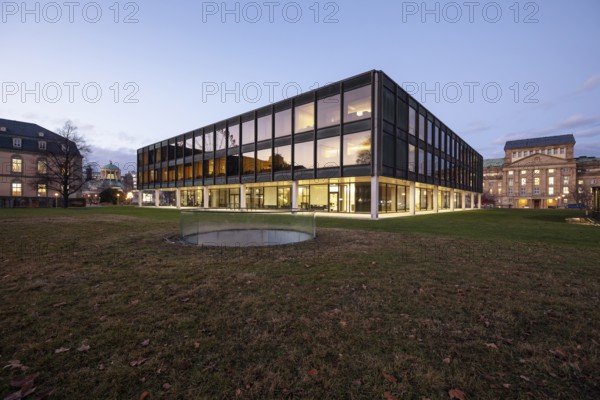 The state parliament of Stuttgart glows impressively in the evening. The architecture is accentuated by the night light and creates a clear, atmospheric atmosphere