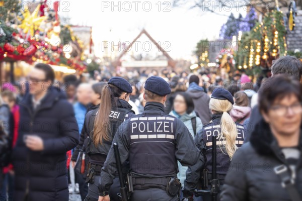 Three police officers are patrolling the Stuttgart 2025 Christmas market. Their presence ensures safety and ensures that visitors can enjoy a carefree celebration