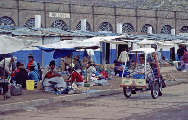 People, woman, market, rickshaw, Puno on Lake Titicaca, Andean highlands, Peru, South America, September 1997, vintage, retro, old, historic