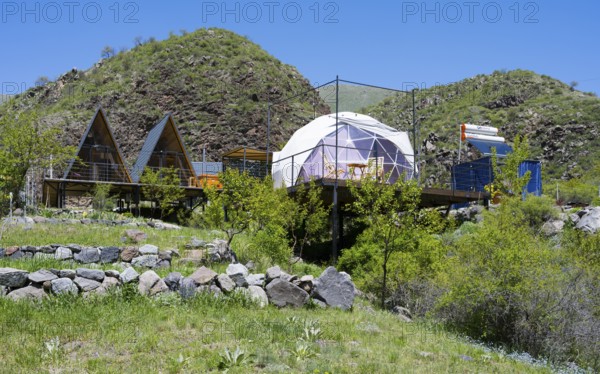 Campsite with huts and tents nestled in rolling green countryside, Vardzia Glamping, Vardzia, Samtske-Javakheti region, Samtske Javacheti, Lesser Caucasus, Georgia