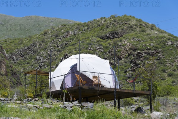 Dome tent on a wooden terrace in green mountain landscape under blue sky, Vardzia Glamping, Vardzia, Samtskhe—Javakheti region, Samtske Javacheti, Lesser Caucasus, Georgia