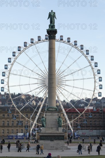 Stuttgart offers a cozy atmosphere in the evening with a view of the illuminated Ferris wheel with the anniversary column in the foreground