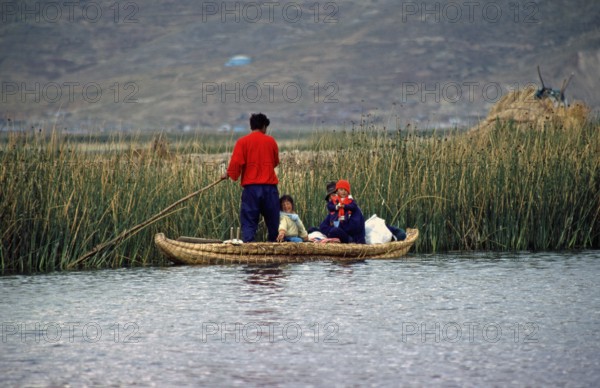Young family with young children in a reed boat, Lake Titicaca, Puno, Andean Highlands, Peru, South America, September 1997, vintage, retro, old, historic