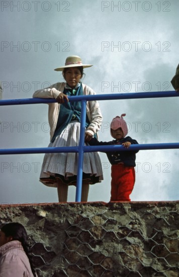 Traditionally dressed young woman with infant, Puno, Andean Highlands, Peru, South America, September 1997, vintage, retro, old, historic