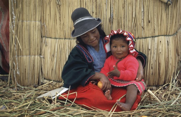 Children sitting in front of a reed hut on a floating Uro island in Lake Titcaca, Peru, South America, September 1997, vintage, retro, old, historic