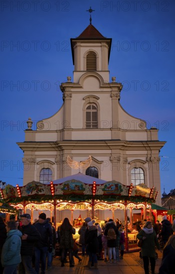 Carousel, catholic church of the Most Holy Trinity, people, visitors, baroque Christmas market, blue hour, dusk, Ludwigsburg, Baden-Württemberg, Germany