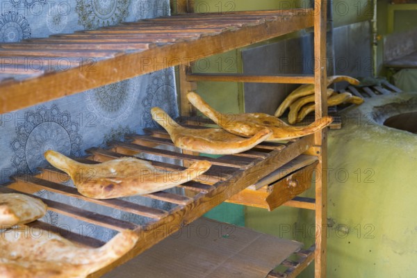 Fresh flatbread on rustic wooden shelves in a bakery, Samtskhe-Javakheti region, Samtskhe-Javakheti, Georgia