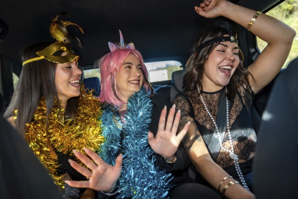 Young women friends celebrating a joyful costume party inside a car, expressing happiness and fun while enjoying the exciting new year's eve event together