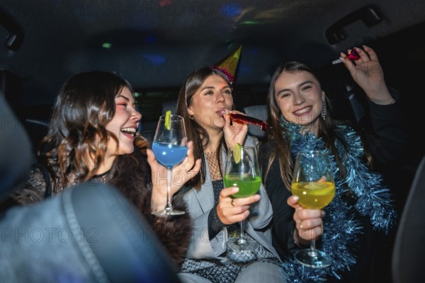 Three happy young women friends celebrating a cheerful new year's eve party in a vehicle, enjoying drinks, party hats, and festive decorations at night