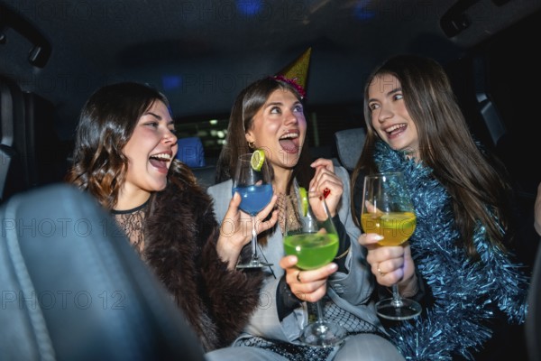 Three friends celebrating a special occasion, laughing and enjoying colorful cocktails while traveling in the back seat of a car at night, creating festive and joyful memories together