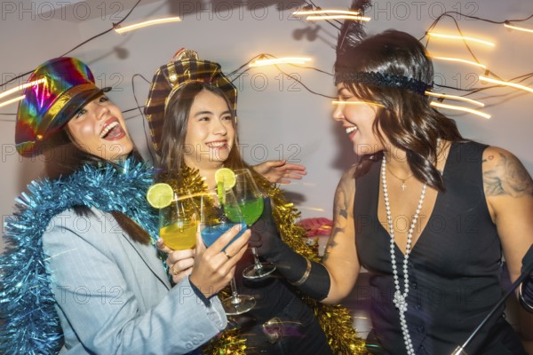 Diverse young adults at a lively new years eve costume party, dressed in festive outfits and headwear, laughing and toasting colorful cocktails in close up celebration