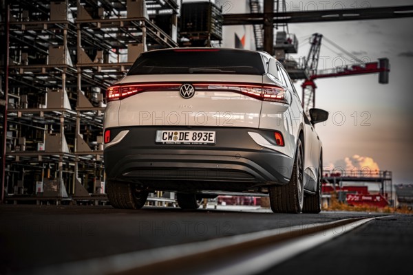 White car against an urban backdrop at sunset, VW ID4 electric car, Deer Carsharing, Calw, Germany