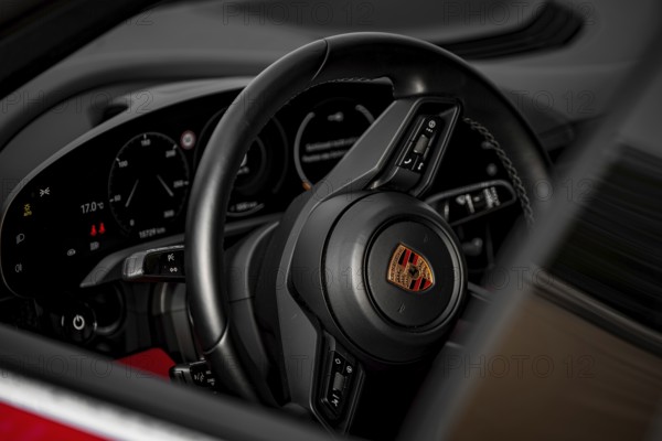 Close-up of Porsche steering wheel and dashboard in modern cockpit design, Porsche Taycan, Deer Carsharing, Calw, Germany