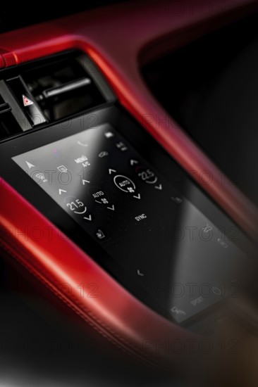 Close-up of car interior with red touchscreen control panel and modern displays, Porsche Taycan, Deer Carsharing, Calw, Germany