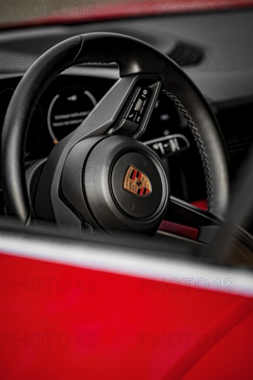 Close-up view of a Porsche steering wheel with modern design elements inside, Porsche Taycan, Deer Carsharing, Calw, Germany