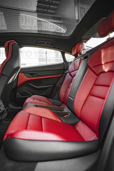 Modern car interior with red and black seats, Porsche Taycan, Deer car sharing. Calw, Germany