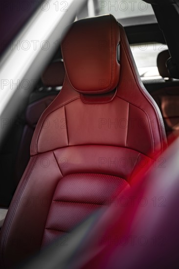 Red leather seat in the luxurious interior of a car, Porsche Taycan, Deer car sharing. Calw, Germany