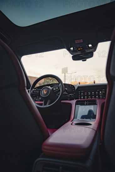 Modern car interior with steering wheel and advanced cockpit, Porsche Taycan, Deer car sharing. Calw, Germany