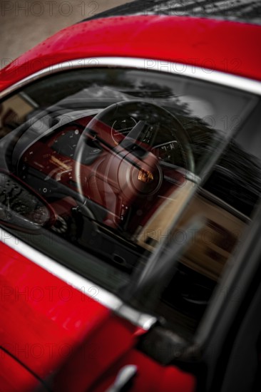 Red car interior with steering pane and reflections in the window, Porsche Taycan, Deer car sharing. Calw, Germany