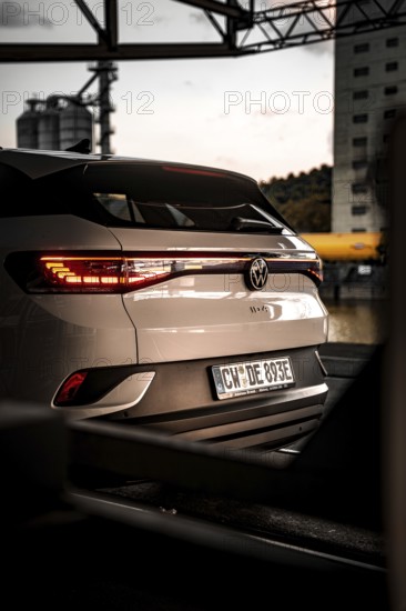 Rear view of a car at dusk in an urban environment, VW ID4 electric car, Deer Carsharing, Calw, Germany