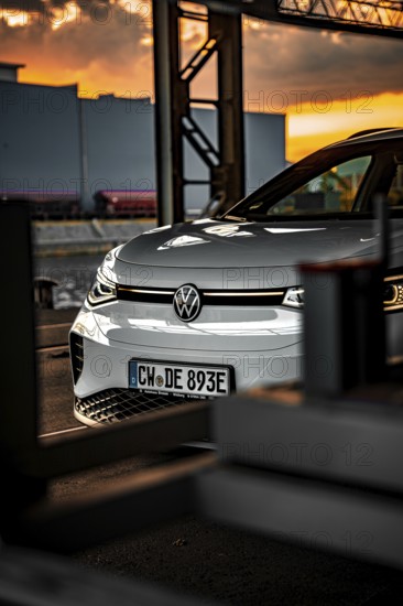 Silver car in industrial area at sunset, VW ID4 electric car, Deer Carsharing, Calw, Germany