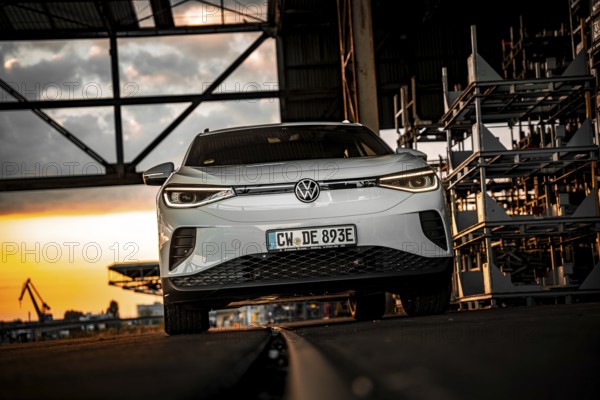 Silver car in an industrial building at dusk, VW ID4 electric car, Deer Carsharing, Calw, Germany