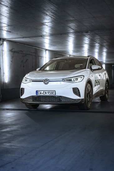 White electric car in an illuminated tunnel with a modern, urban feel, VW ID4 electric car, Deer Carsharing, Calw, Germany